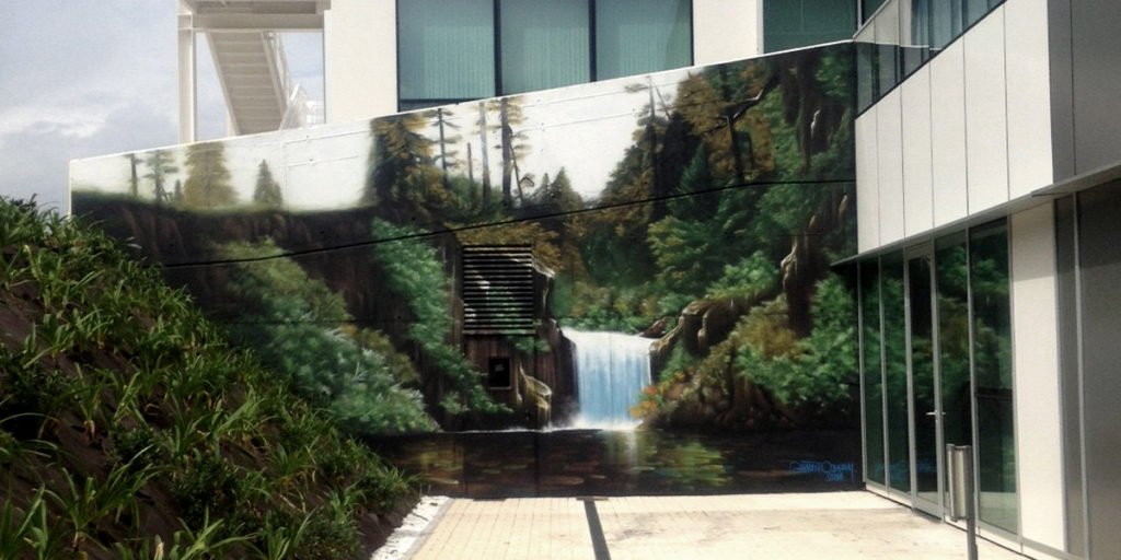Graffiti de paisaje con cascada Graffiti profesional en Gijón