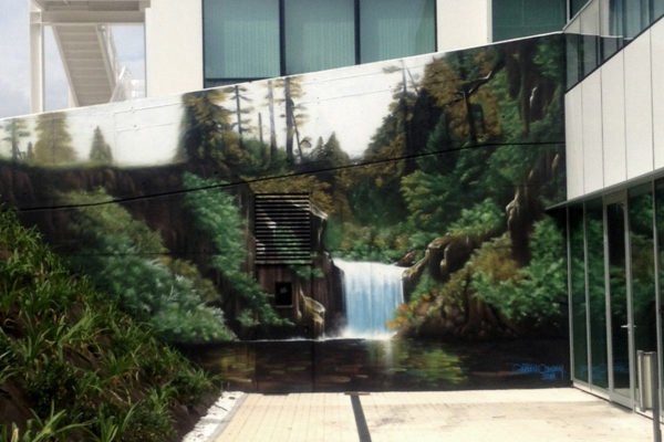 Graffiti de paisaje con cascada Graffiti profesional en Gijón