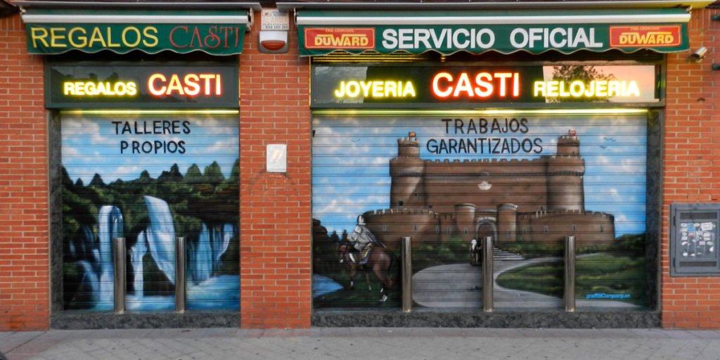 Graffiti-en-persianas-relojeria-Castillo Graffiti en persianas de relojería en Madrid