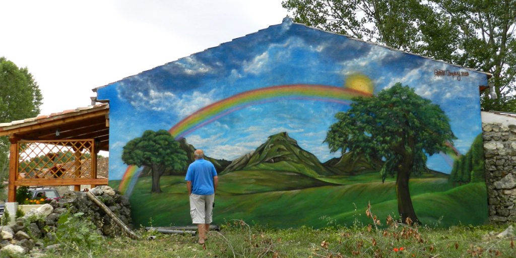 paisaje-de-montana-con-arcoiris-en-fachada Graffiti mural con arcoiris en fachada